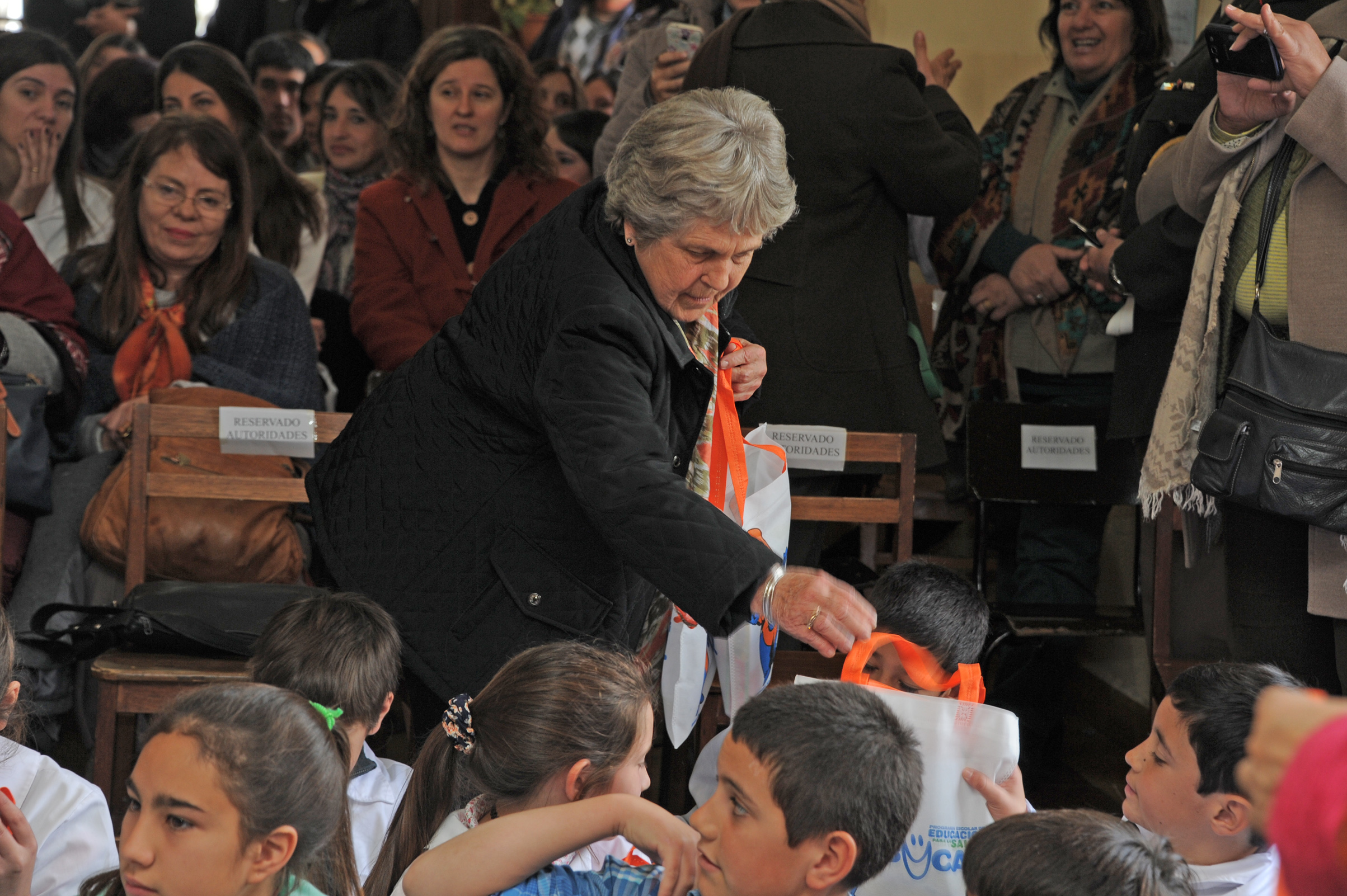 María Auxiliadora Delgado, entregando el material didáctico a los escolares