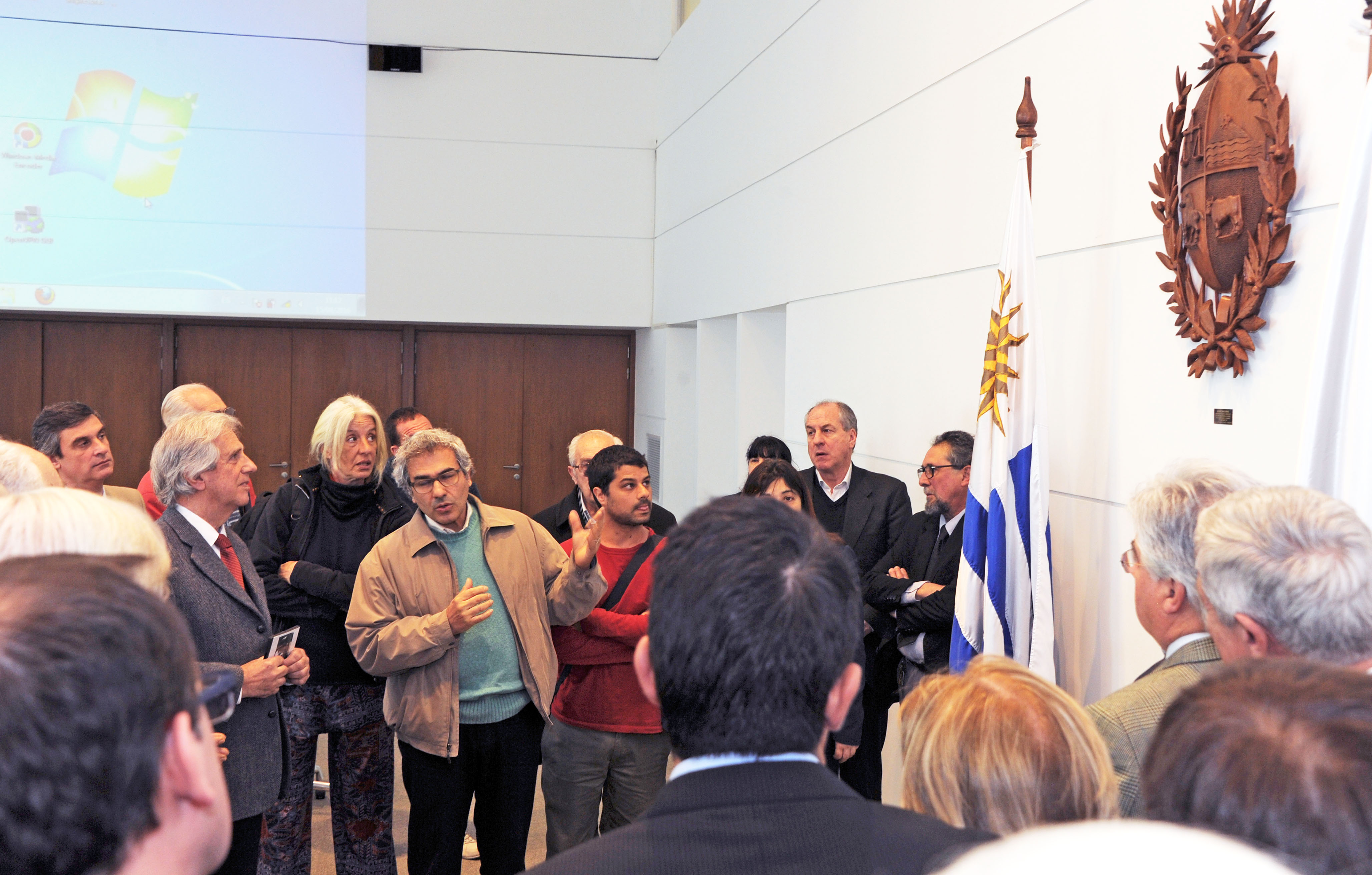 Vázquez, ministros y representantes de la UTU observan el Escudo Nacional en madera