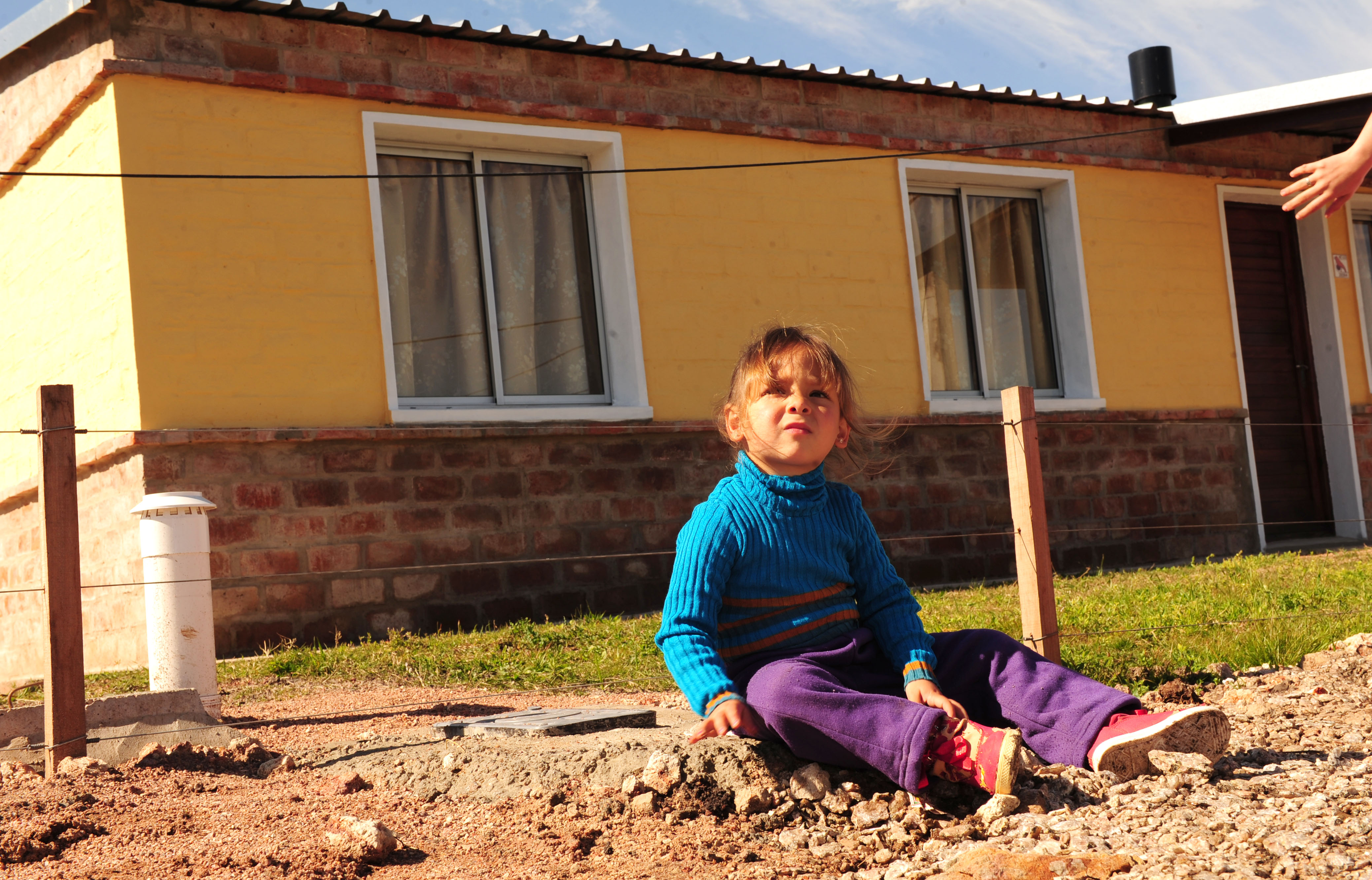 Niña en la puerta de su nueva casa