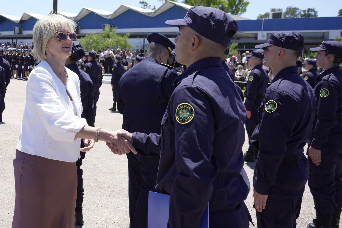 La subsecretaria del Interior estrecha la mano de un policía en fila en el evento de egreso de agentes policiales.