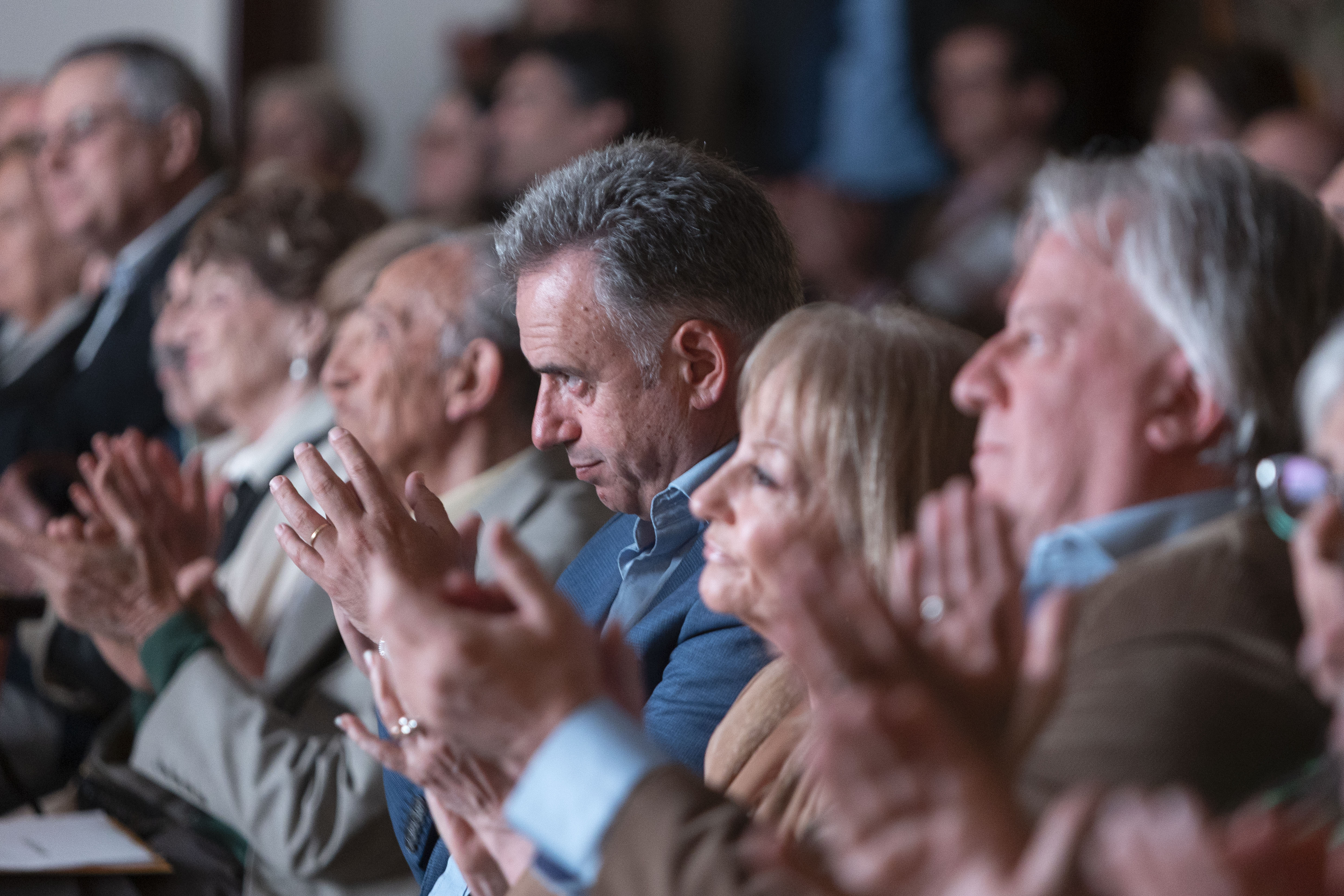 Orsi junto a la vicepresidenta de la República y otras autoridades sentado en primera fila aplaude en el aniversario de Cinve.